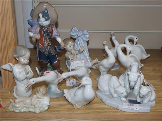 A Lladro figure of Puss in Boots, figure group of three polar bears, Baby Blanket, Sleeping Child, Angel and seven ducks tallest 22cm